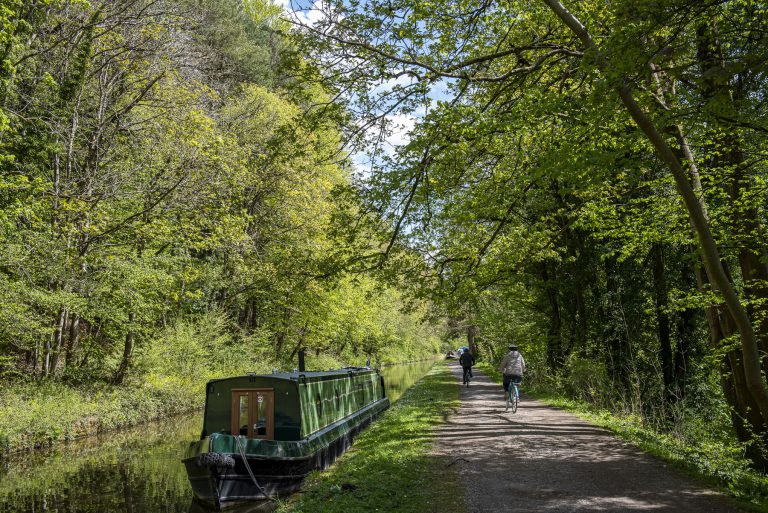 Cyclists and barge along Avon and Kennet Canal